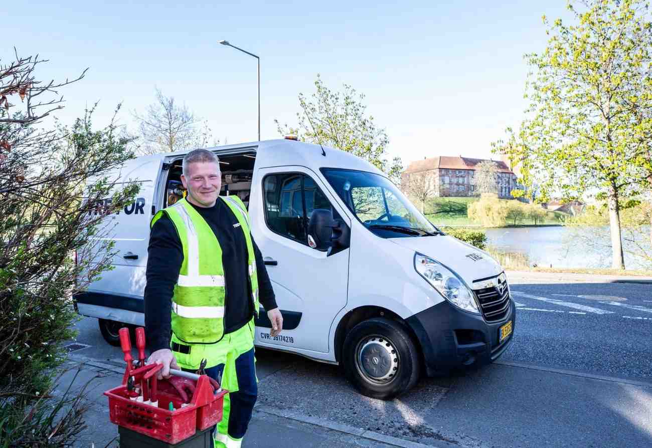 Worker with toolbox by van