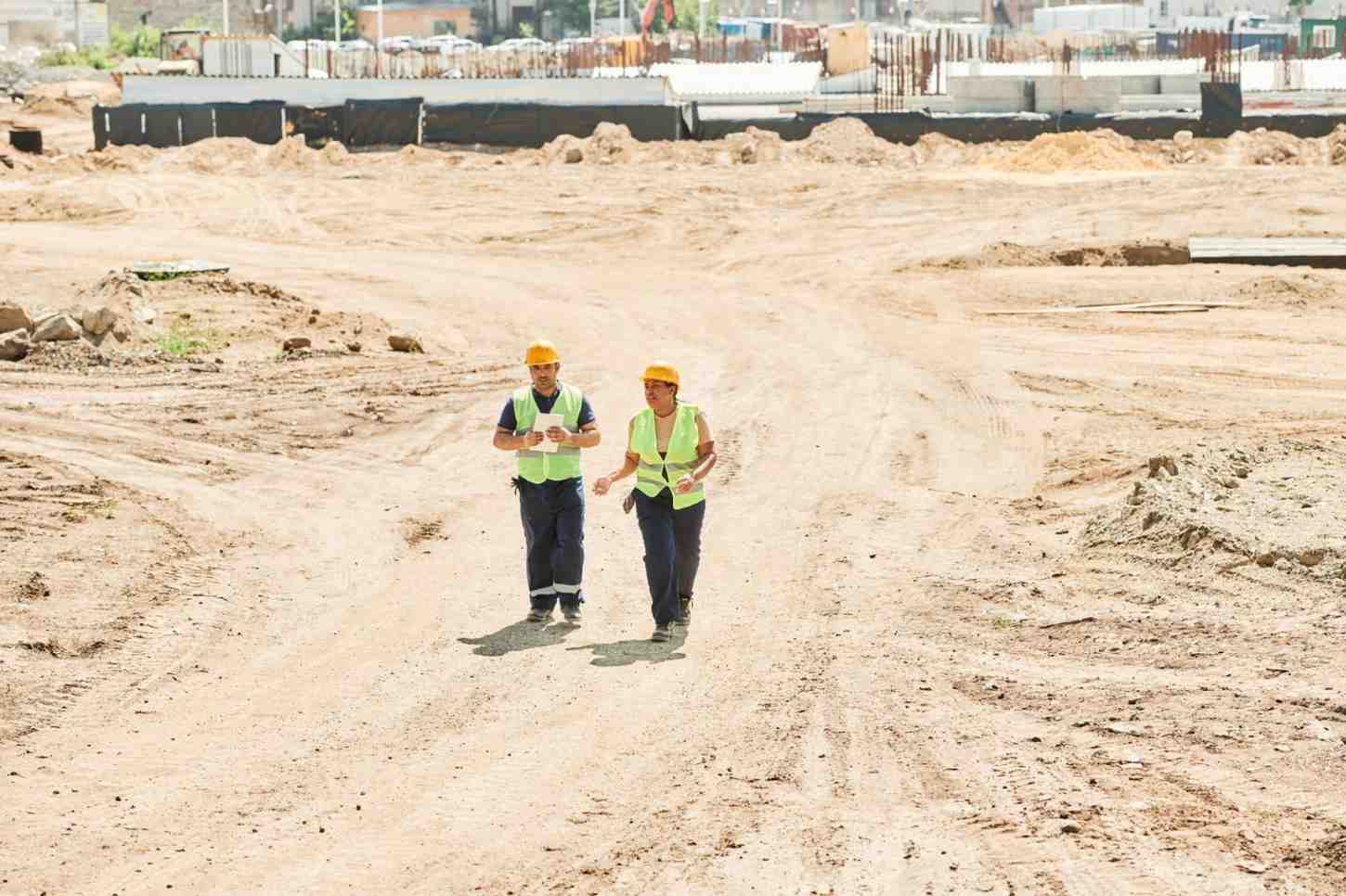 Two workers walking on site