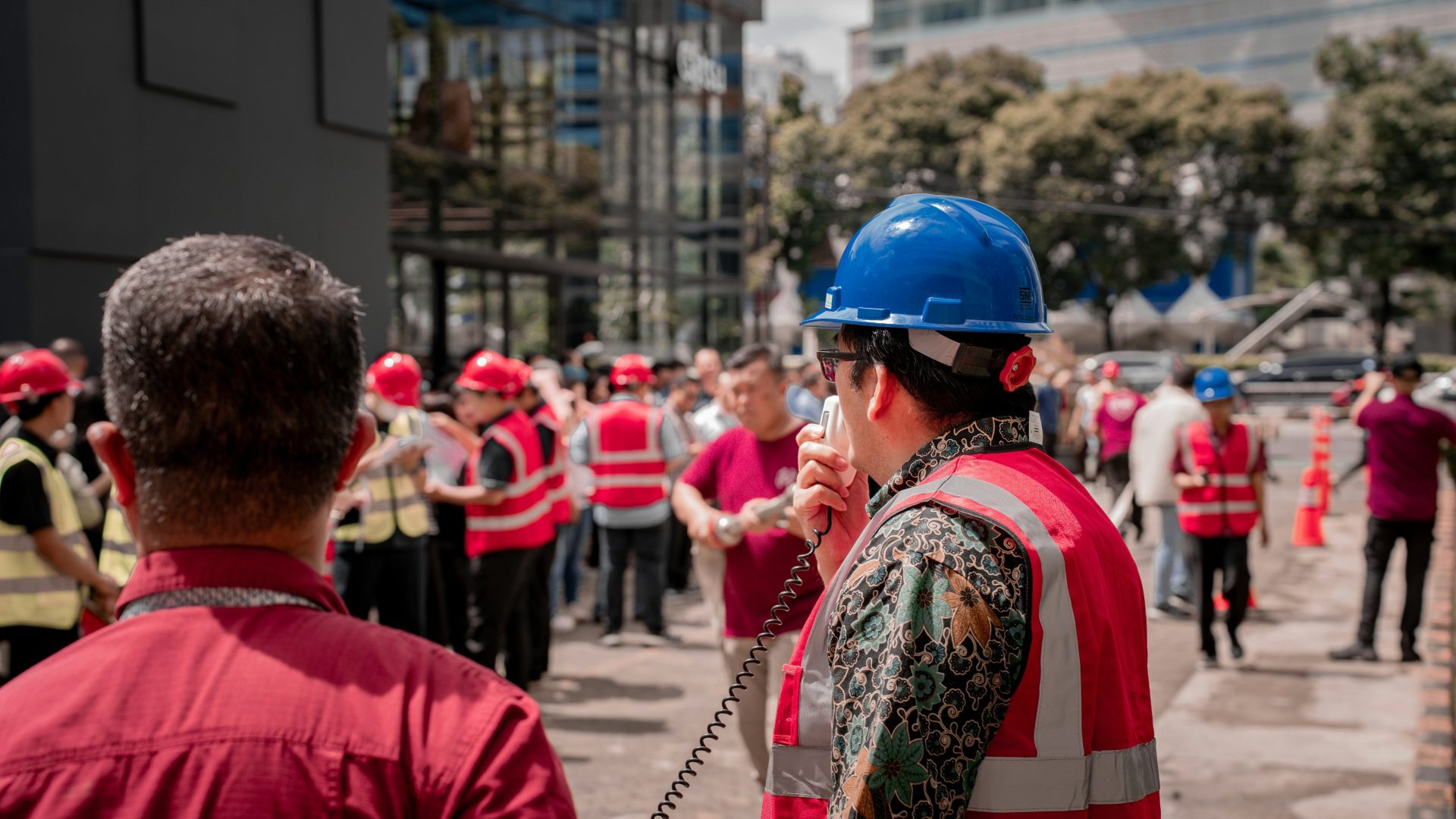 Foreman speaking into walkie-talkie to construction workers