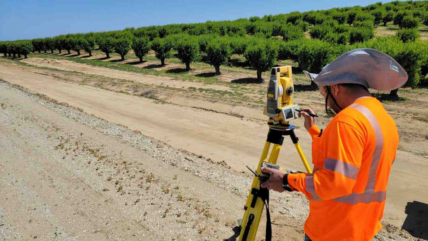Surveyor working in orchard