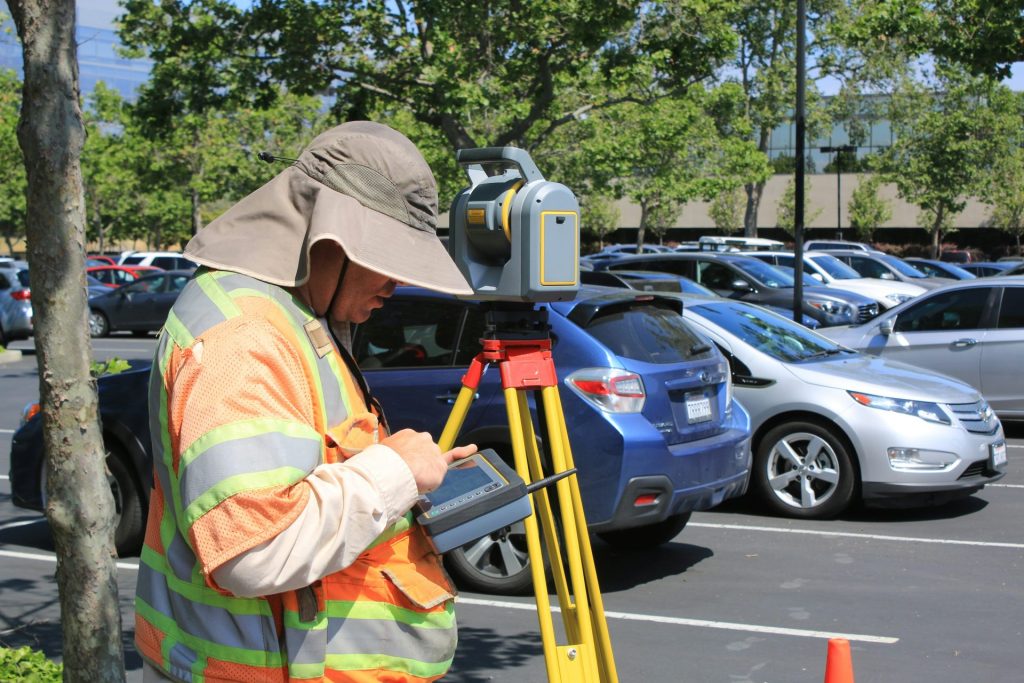 Surveyor using equipment outdoors