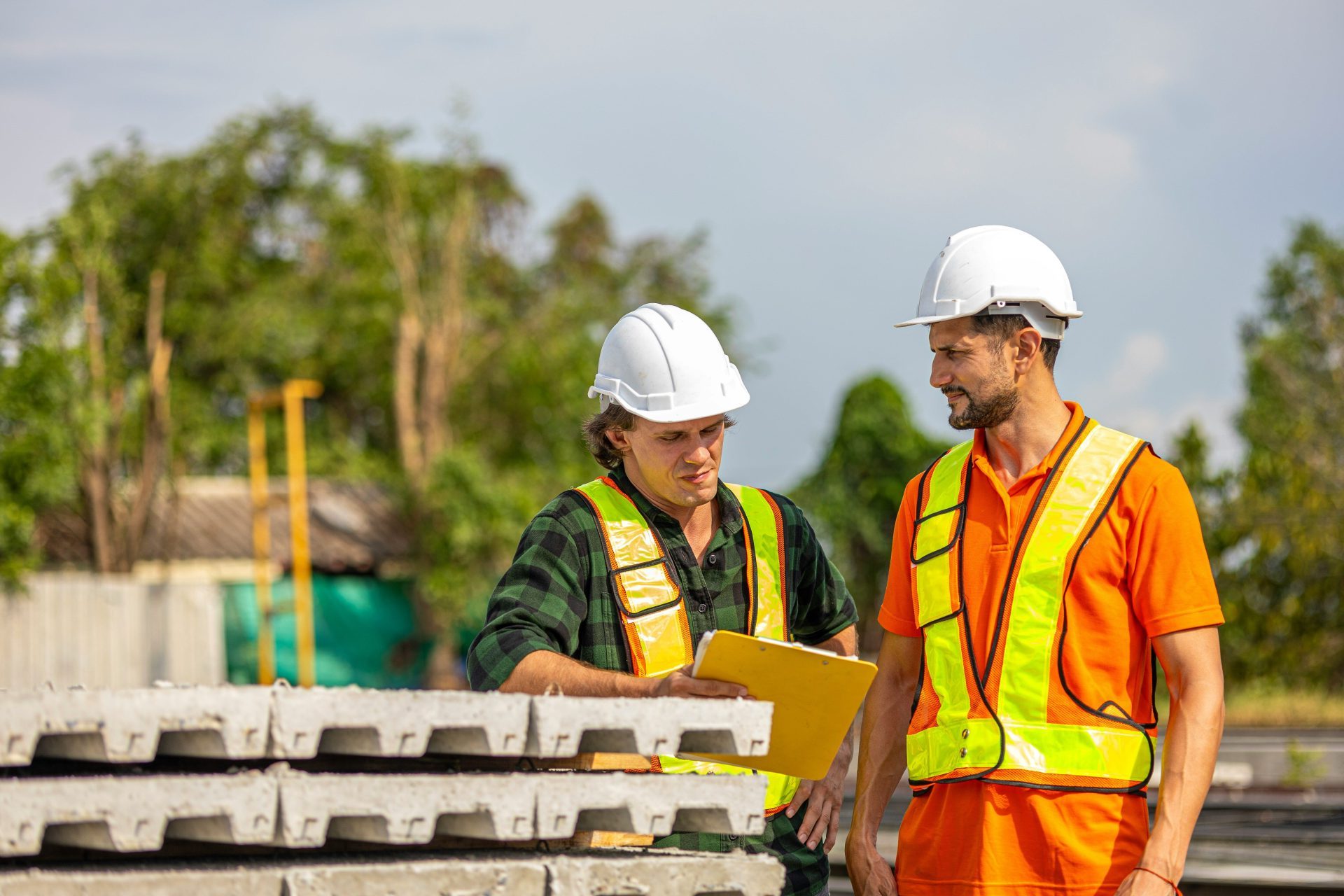 Construction workers review plans on site.